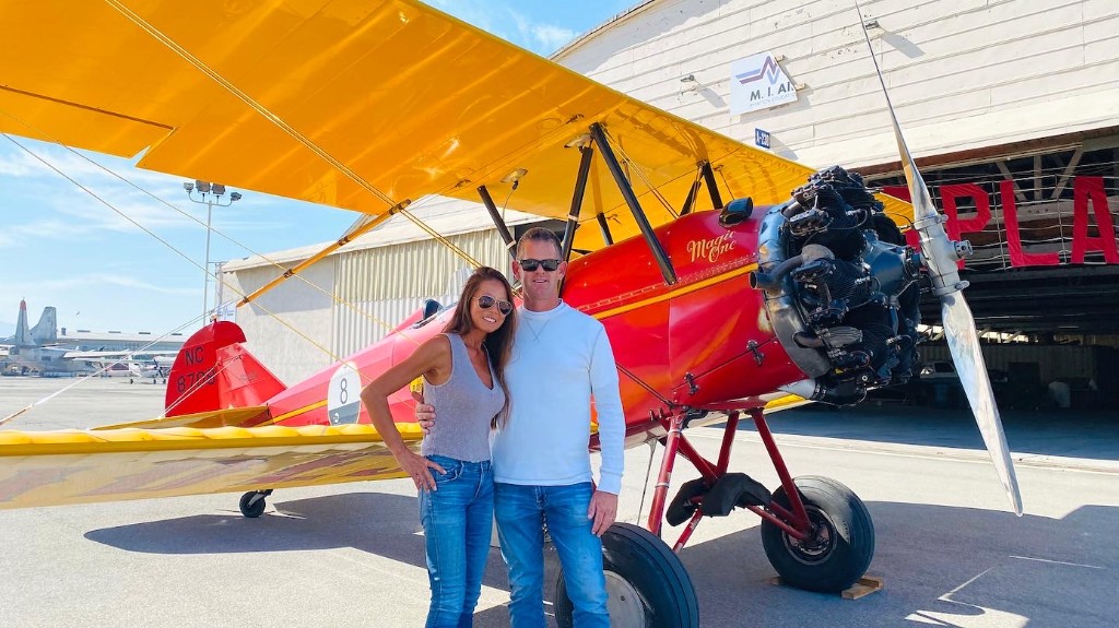Scott Magner and his wife today beside the same red biplane